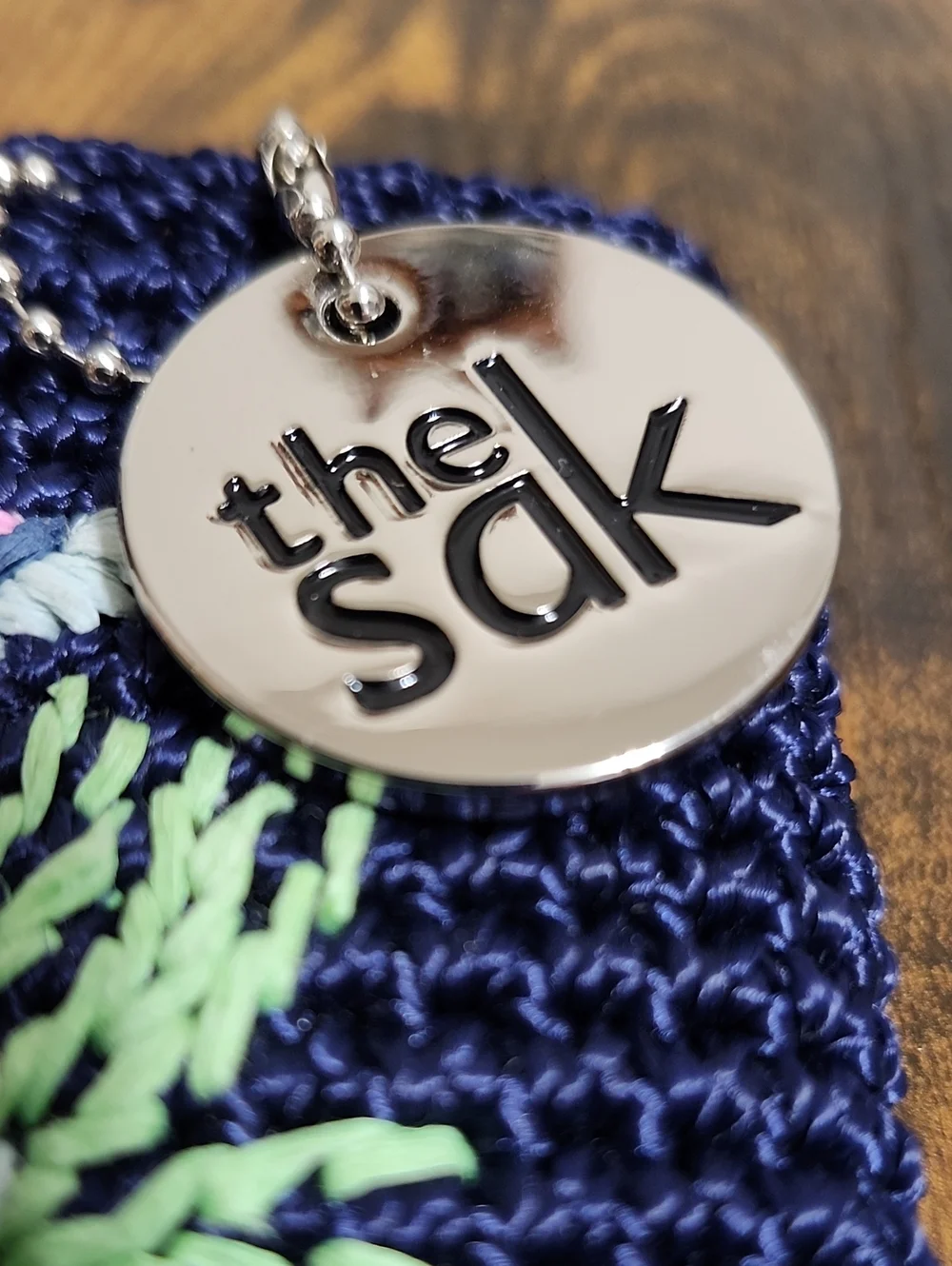 The Sak Navy Crochet Wristlet with Silver Logo Charm, NWT